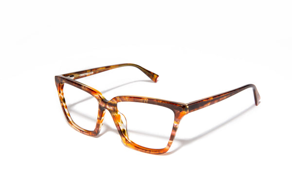 Image of Cheeterz Club eyewear. Photo of cat eye eyeglasses with clear lenses and blue light blocking technology. The frames are medium width and golden brown color with honey and dark brown accents. Suitable for round, oval, and heart shaped face shapes. These glasses can be used as reading glasses with blue light glasses.